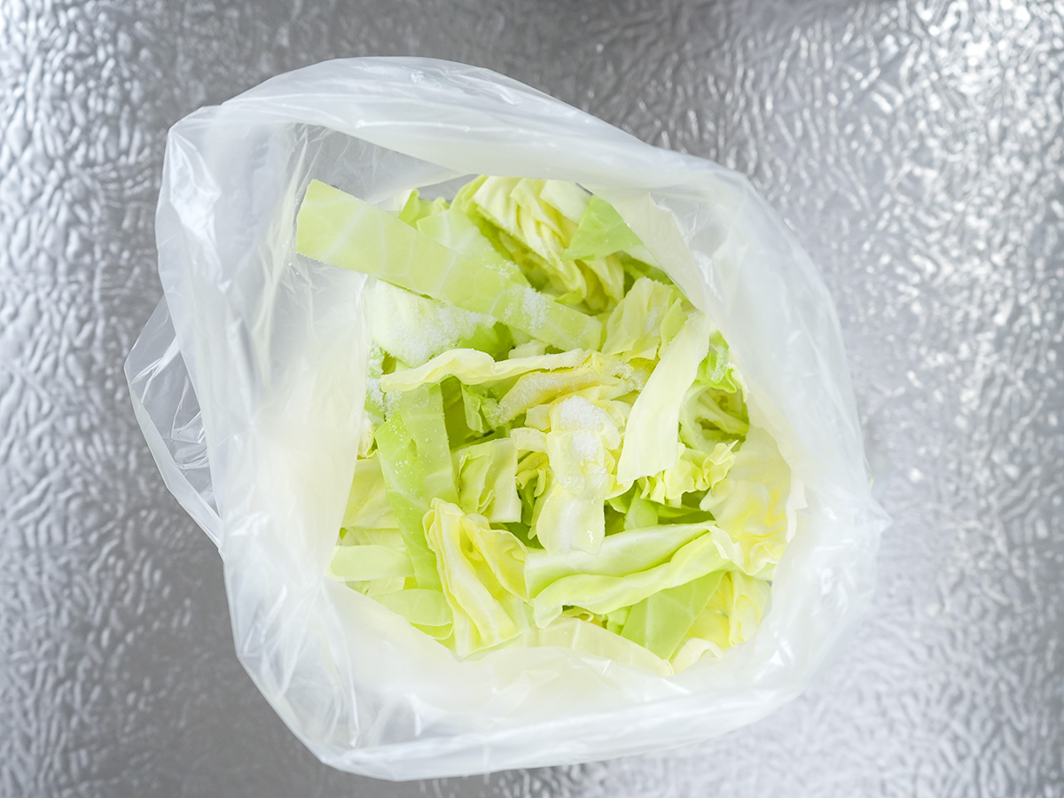 ポリ袋にキャベツと塩入れたシーン